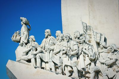 Low angle view of statue against clear blue sky