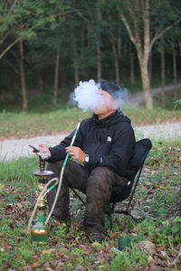 Rear view of woman standing in forest