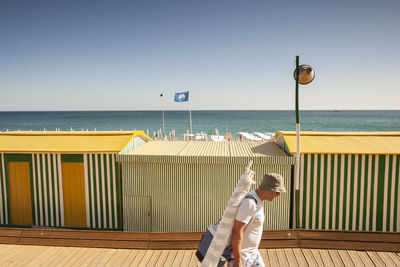 Man standing on beach against clear sky