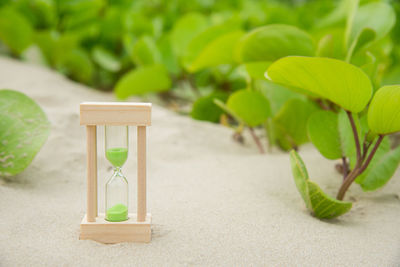 Hourglass on sand at beach