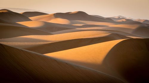 Scenic view of desert against sky during sunset