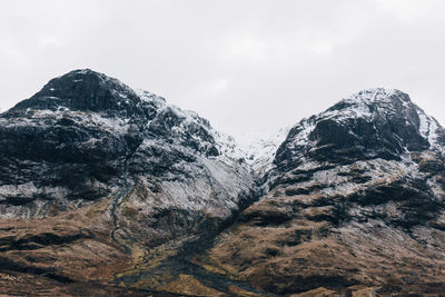 Low angle view of majestic mountains against sky