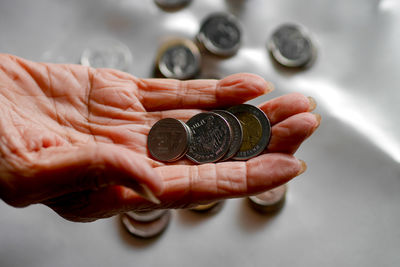 Cropped hand of person holding bitcoin