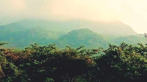 Scenic view of mountains against sky during foggy weather