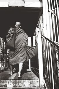 Rear view of monk walking