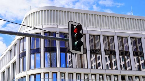 Traffic light against modern building