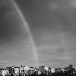 Rainbow over buildings in city