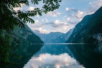 Scenic view of lake by mountains against sky