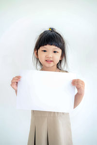 Portrait of a smiling girl over white background