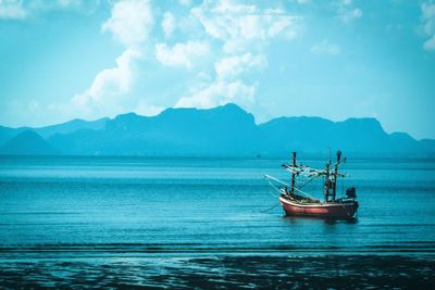 Sailboat in sea against sky