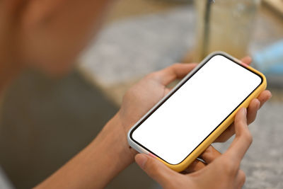 Midsection of person using mobile phone