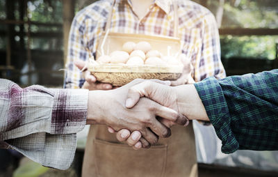 Midsection of couple holding hands