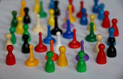 Close-up of colorful ludo tokens on white background