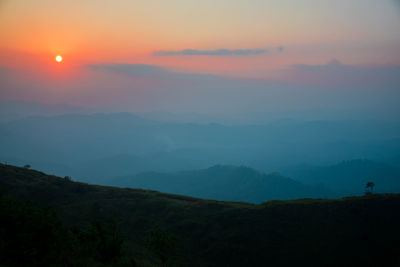 Scenic view of silhouette mountains against sky during sunset