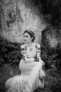 Portrait of woman sitting on rock