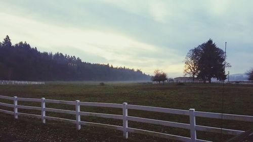 Scenic view of field against cloudy sky