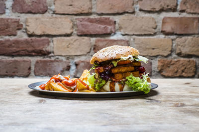 Close-up of food on table against brick wall