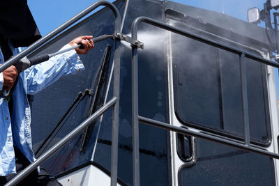 Low angle view of man on metal railing