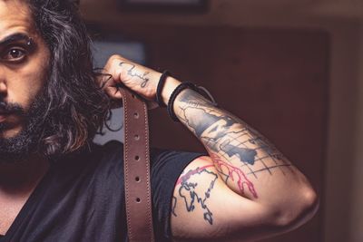 Close-up of woman with tattoo at home