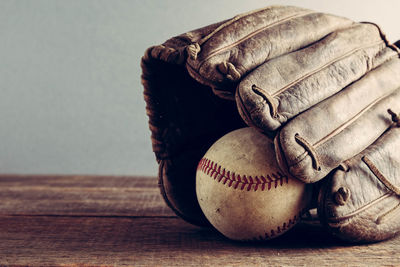 Close-up of baseball glove and ball on table