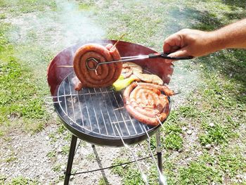 High angle view of person preparing food on barbecue grill