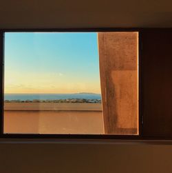 Close-up of window against sky during sunset