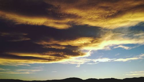 Scenic view of landscape against cloudy sky