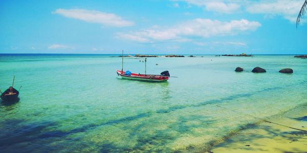 Boat moored on sea against sky