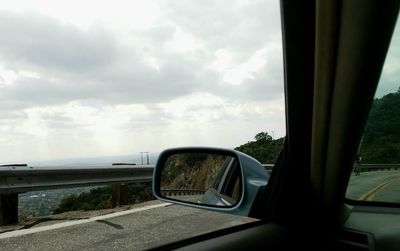 Close-up of vintage car on sea against sky