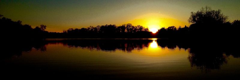 Scenic view of lake at sunset