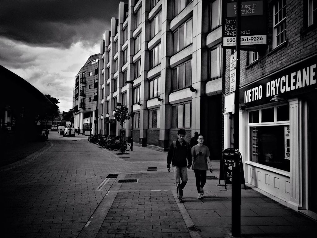 building exterior, architecture, built structure, full length, men, walking, rear view, city, lifestyles, street, city life, person, leisure activity, casual clothing, the way forward, sky, building