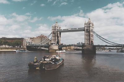 View of bridge over river against cloudy sky