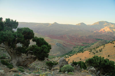 Scenic view of landscape and mountains against clear sky