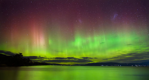 Scenic view of lake against sky at night