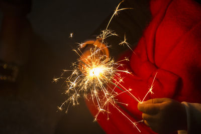 Low angle view of firework display at night