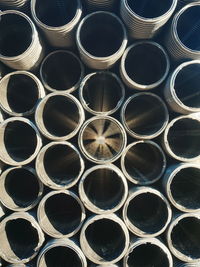 Full frame shot stacked steel pipes