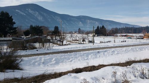 Scenic view of snow covered mountains against sky