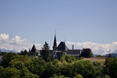 Panoramic view of trees and buildings against sky