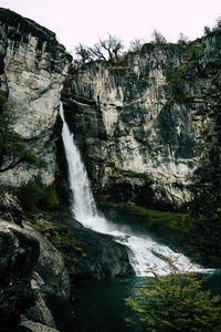 Scenic view of waterfall in forest in autumn