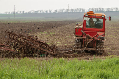 Tractor on field against sky