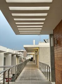 Low angle view of staircase amidst buildings against sky