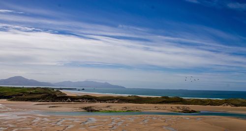 Scenic view of sea against blue sky