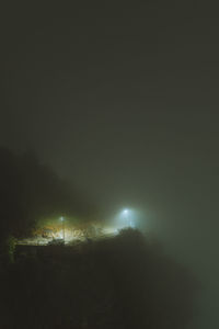 Illuminated city against sky at night