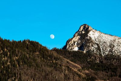 Low angle view of moon against blue sky