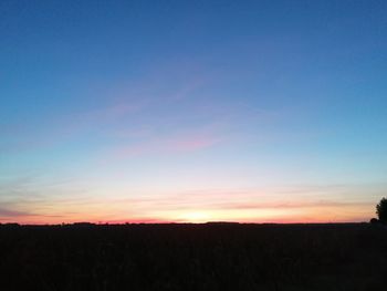 Silhouette landscape against sky during sunset