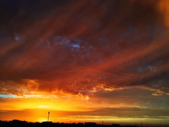 Scenic view of dramatic sky at sunset