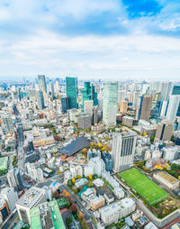 High angle view of modern buildings in city against sky