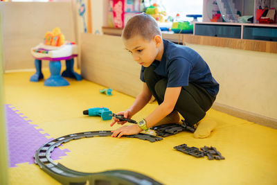 Boy playing with toy at home