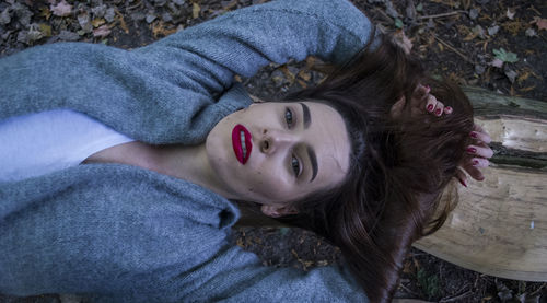 Portrait of woman lying in forest