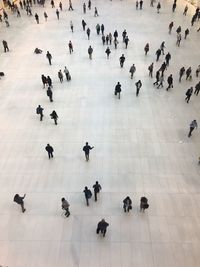 High angle view of people walking on tiled floor